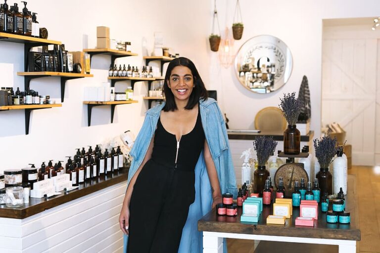 A smiling local shop owner in a retail store